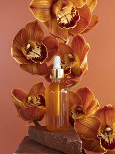 featured herbal oil with floral background